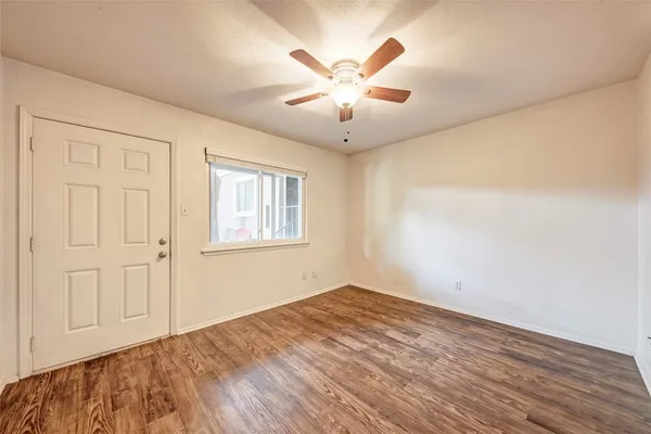 wooden floor in an empty room with a window