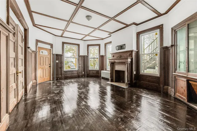 a view of a livingroom with a fireplace and window
