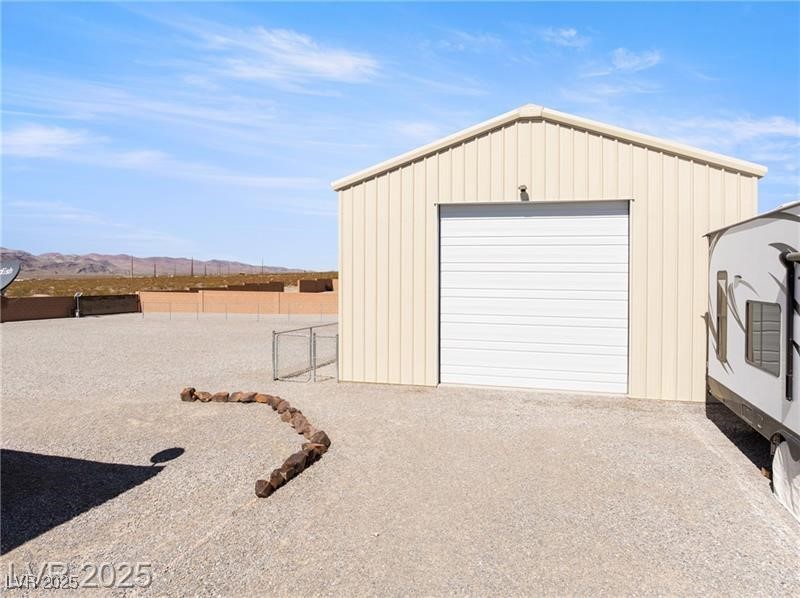 760 Fort Churchill Road Pahrump, NV 89060 - Photo 21 of 33 Detached garage featuring a mountain view and driveway