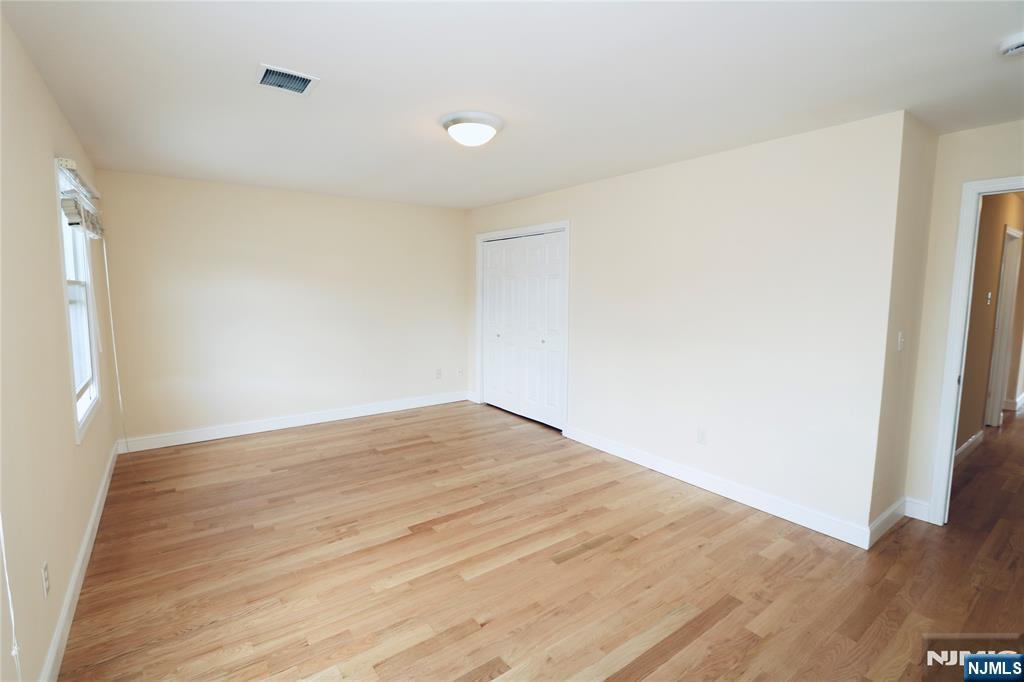 23 Main Avenue Wallington, NJ 07057 - Photo 26 of 29 a view of empty room with wooden floor