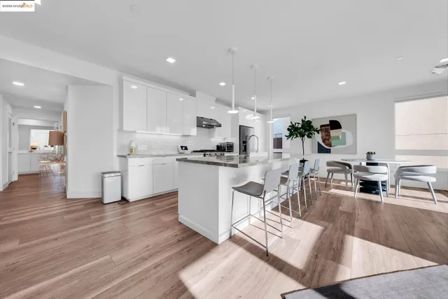 a kitchen with kitchen island a sink stainless steel appliances and cabinets