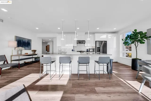 a kitchen with white cabinets and counter space