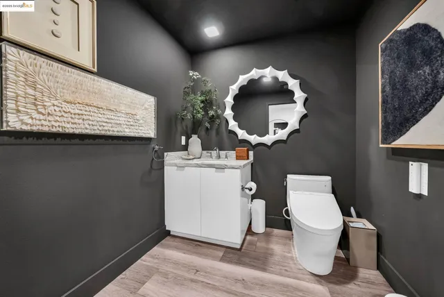 a large living room with stainless steel appliances kitchen island granite countertop furniture a rug kitchen view and a fireplace