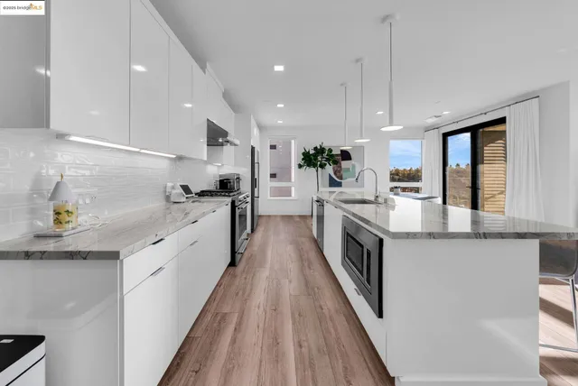 a large kitchen with stainless steel appliances double vanity and a sink