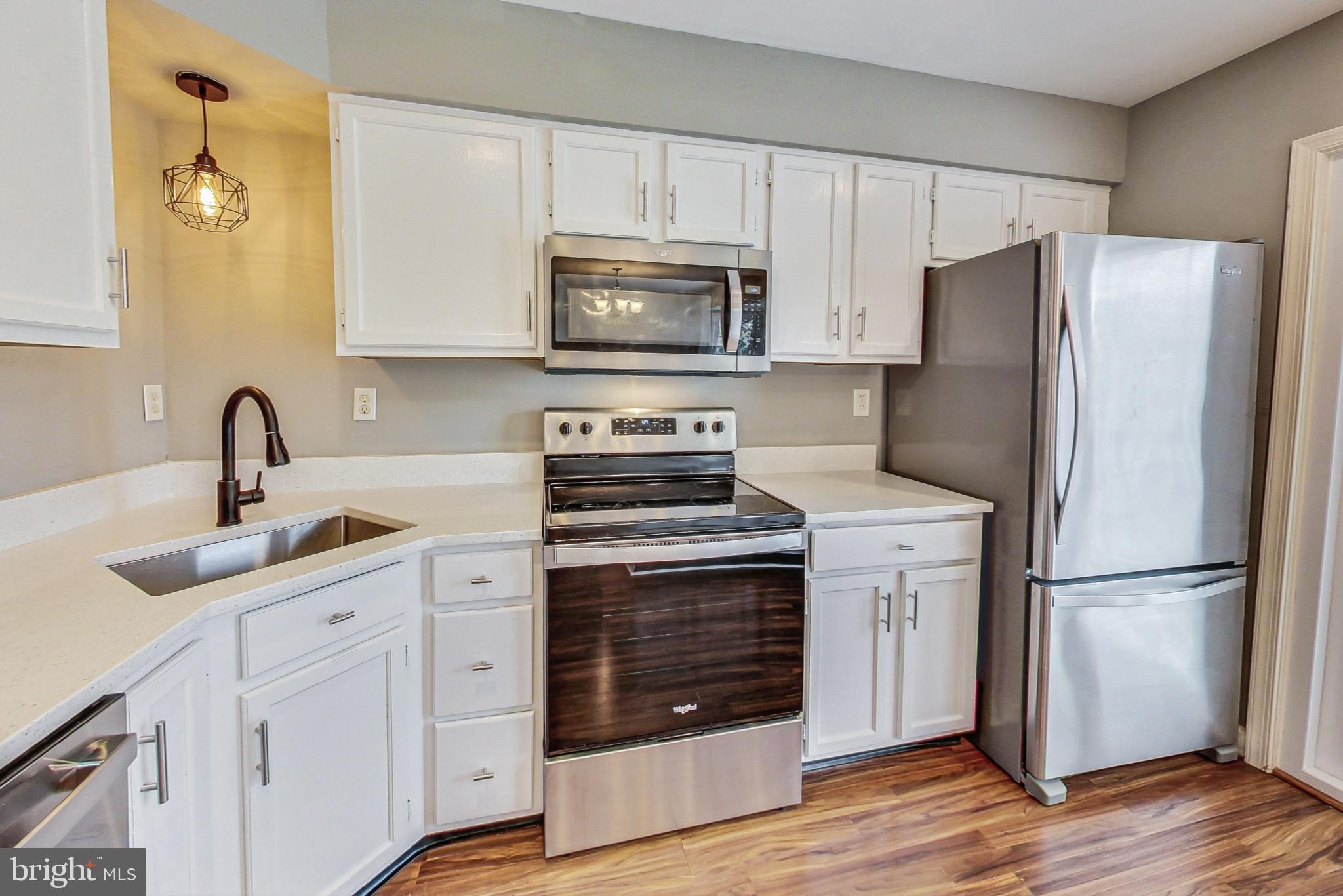 6119 Baldridge Circle Frederick, MD 21701 - Photo 12 of 43 a kitchen with cabinets stainless steel appliances and wooden floor