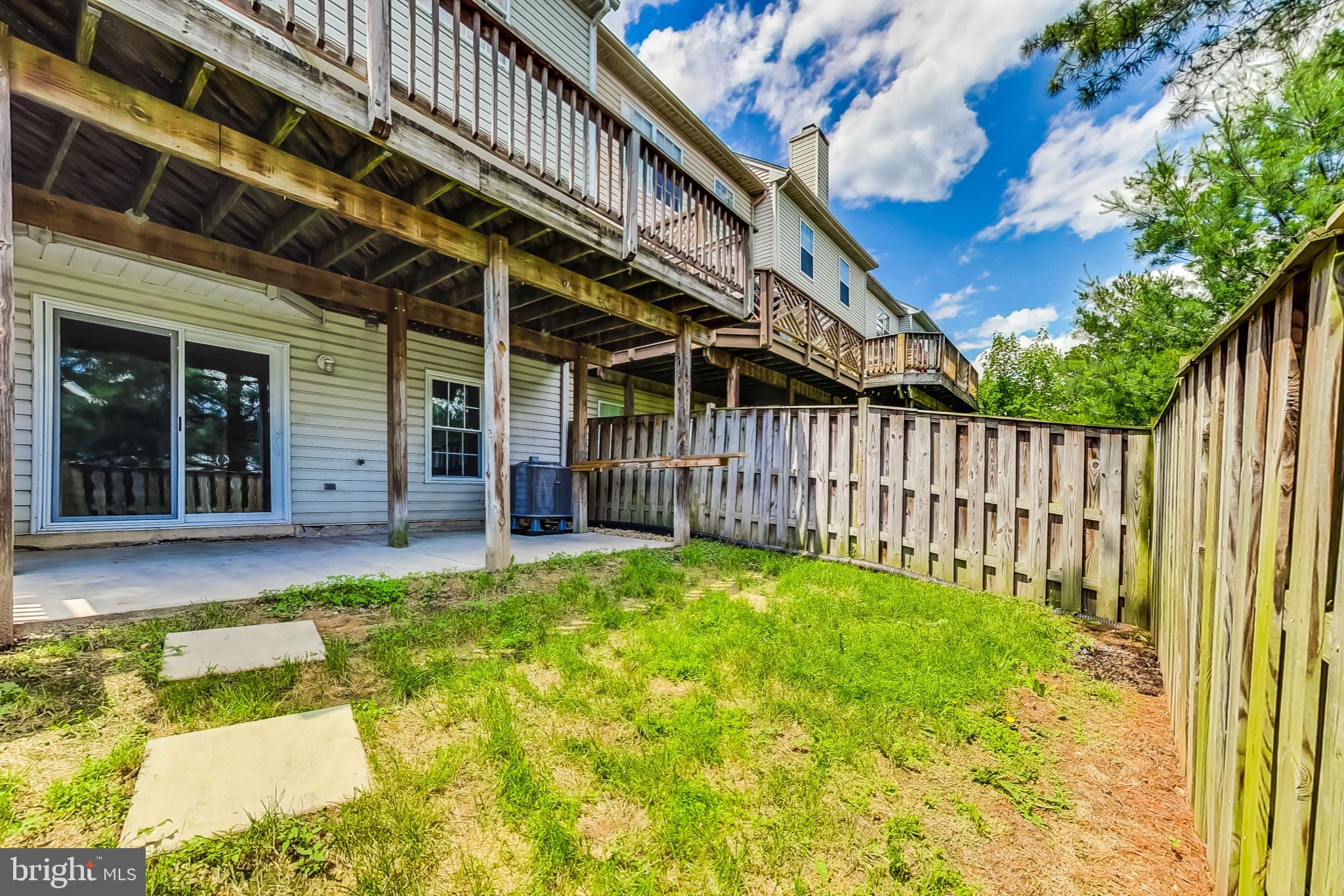 6119 Baldridge Circle Frederick, MD 21701 - Photo 31 of 43 a view of a backyard with brick wall and potted plants