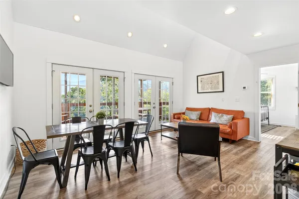 a dining room with furniture and wooden floor