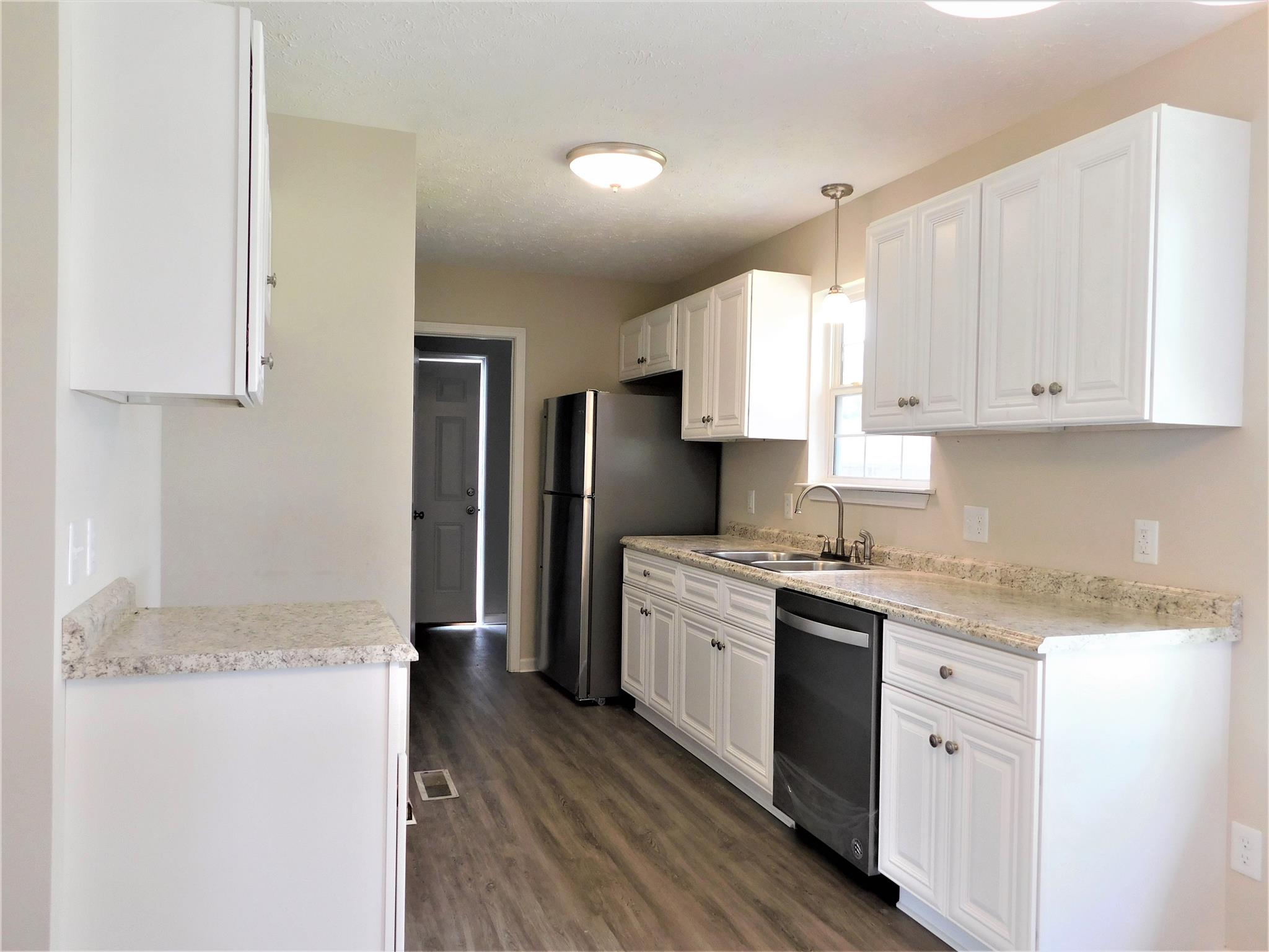 121 Rodeo Drive Columbia, TN 38401 - Photo 2 of 10 Kitchen has new flooring, new cabinets, all repainted, new stainless steel appliances, to include new stove, new dishwasher & new refrigerator.