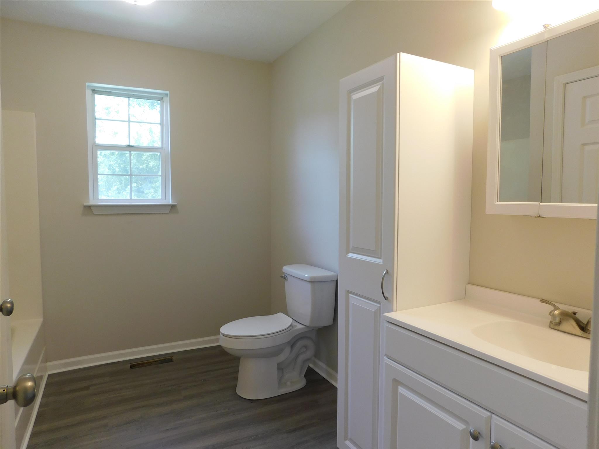121 Rodeo Drive Columbia, TN 38401 - Photo 9 of 10 Hall Bath has new vanity, new flooring, new mirror, linen cabinet, new combo tub/shower, all repainted.