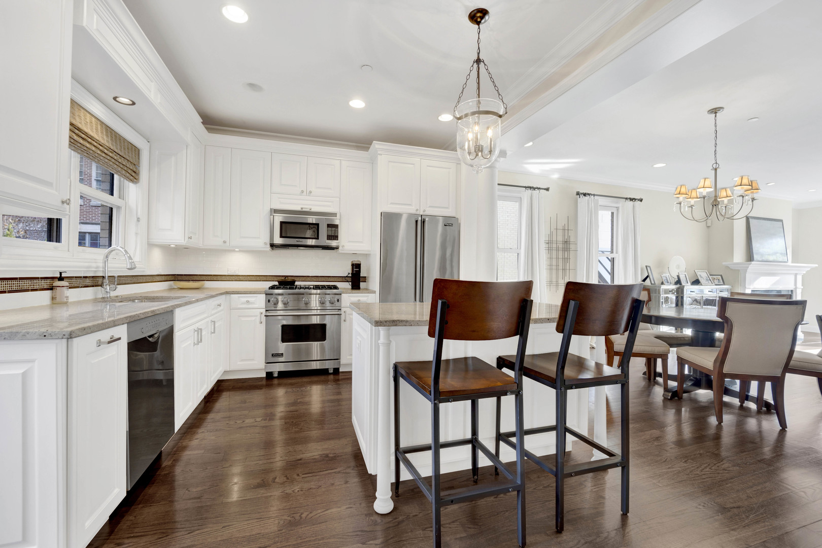 460 Pennsylvania Avenue, Unit C Glen Ellyn, IL 60137 - Photo 11 of 37 a kitchen with a dining table chairs stainless steel appliances and cabinets