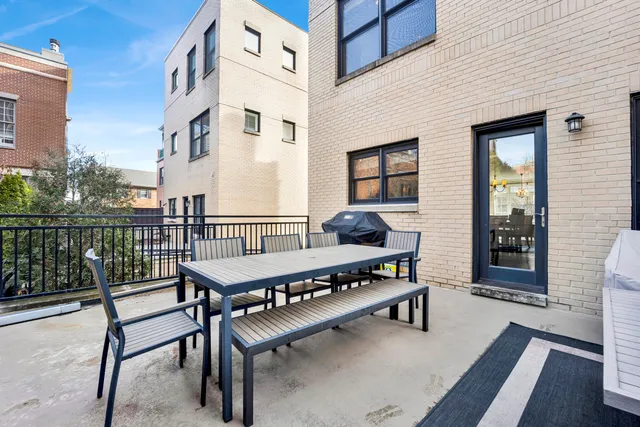 a balcony with a table and chairs