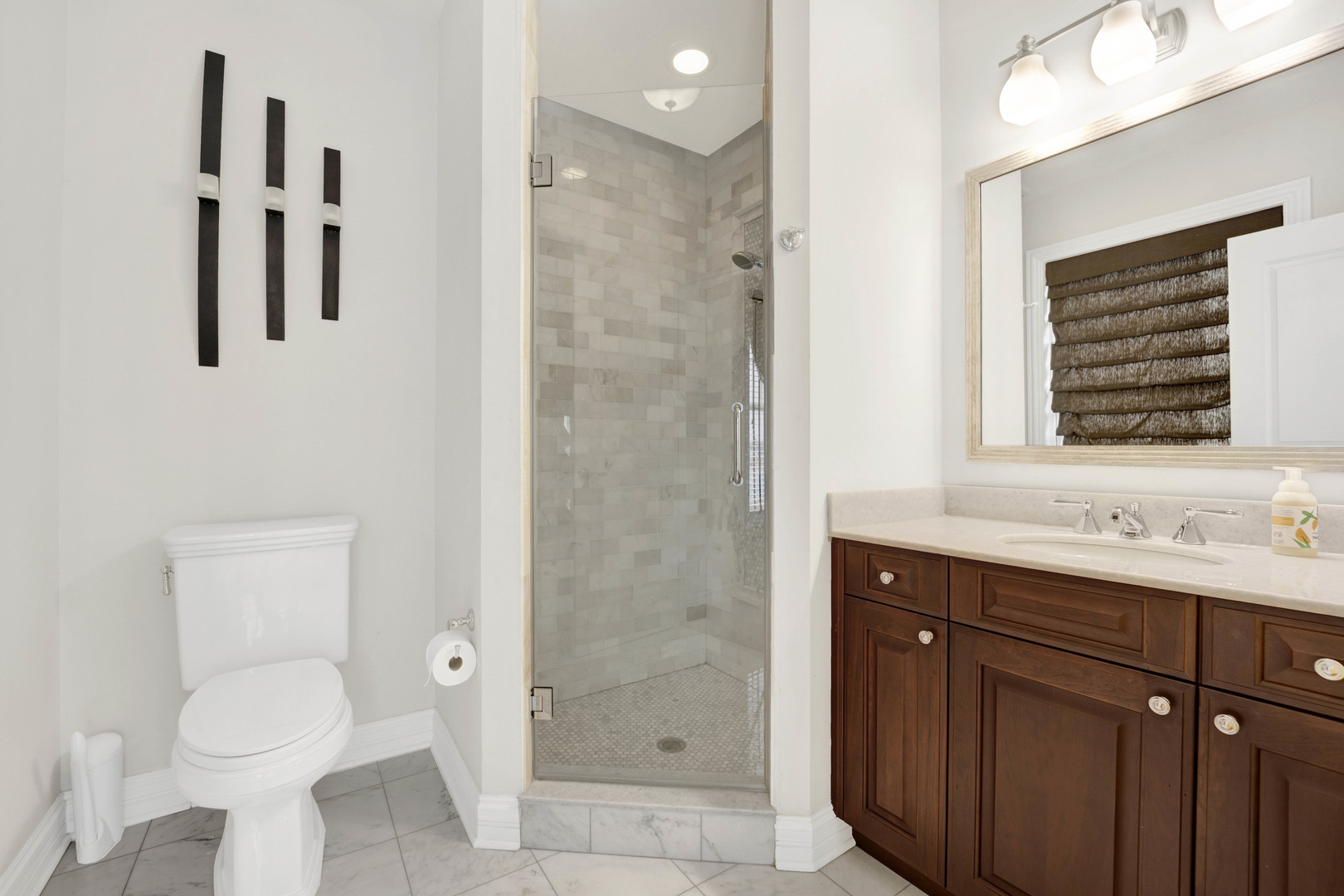 460 Pennsylvania Avenue, Unit C Glen Ellyn, IL 60137 - Photo 33 of 37 a bathroom with a toilet sink a shower and a mirror