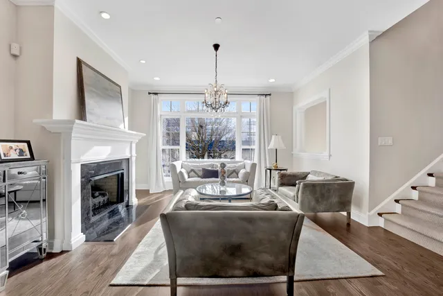 a living room with furniture fireplace and window