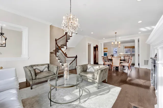 a living room with lots of furniture and a chandelier