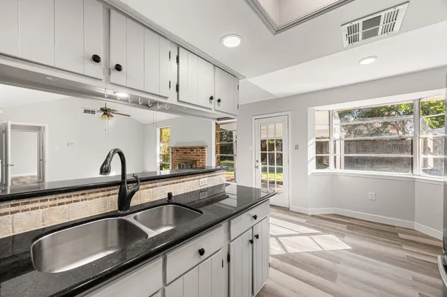a kitchen with granite countertop a sink and a window