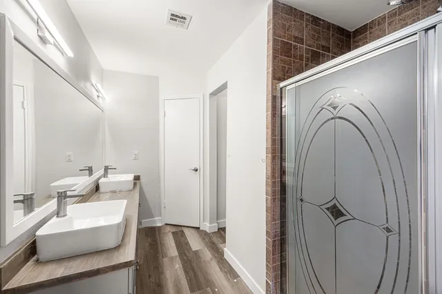 a en suite bathroom with a sink mirror and toilet