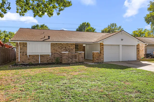a view of a house with a yard and garage