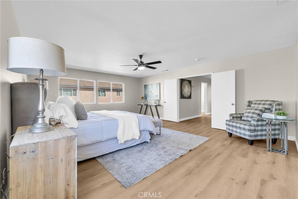 6732 Rico Court Eastvale, CA 92880 - Photo 14 of 30 a bedroom with furniture and a wooden floor