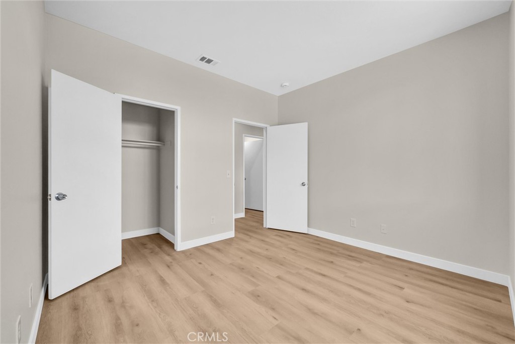 6732 Rico Court Eastvale, CA 92880 - Photo 21 of 30 a view of an empty room with wooden floor