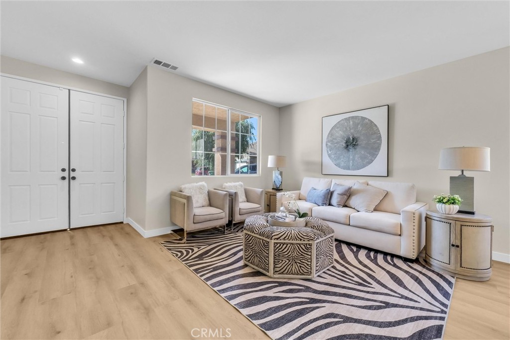 6732 Rico Court Eastvale, CA 92880 - Photo 6 of 30 a living room with furniture and a window