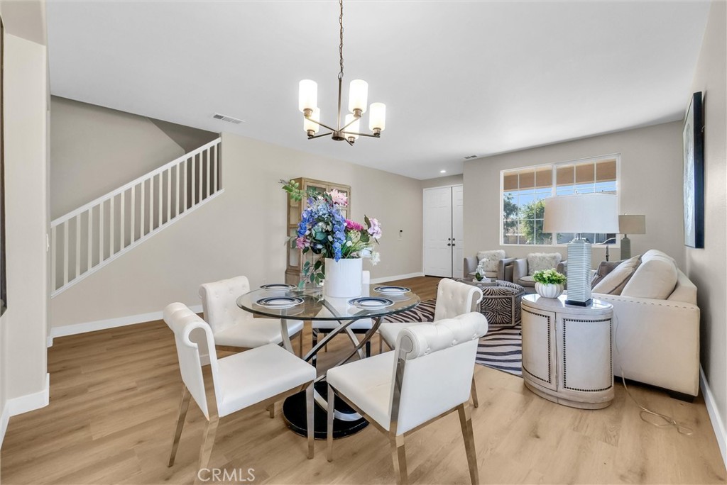 6732 Rico Court Eastvale, CA 92880 - Photo 7 of 30 a view of a dining room with furniture window and wooden floor
