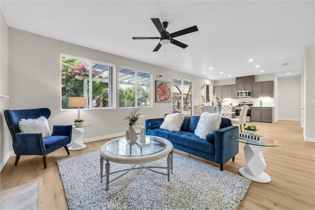 6732 Rico Court Eastvale, CA 92880 - Photo 9 of 30 a living room with furniture kitchen view and a wooden floor