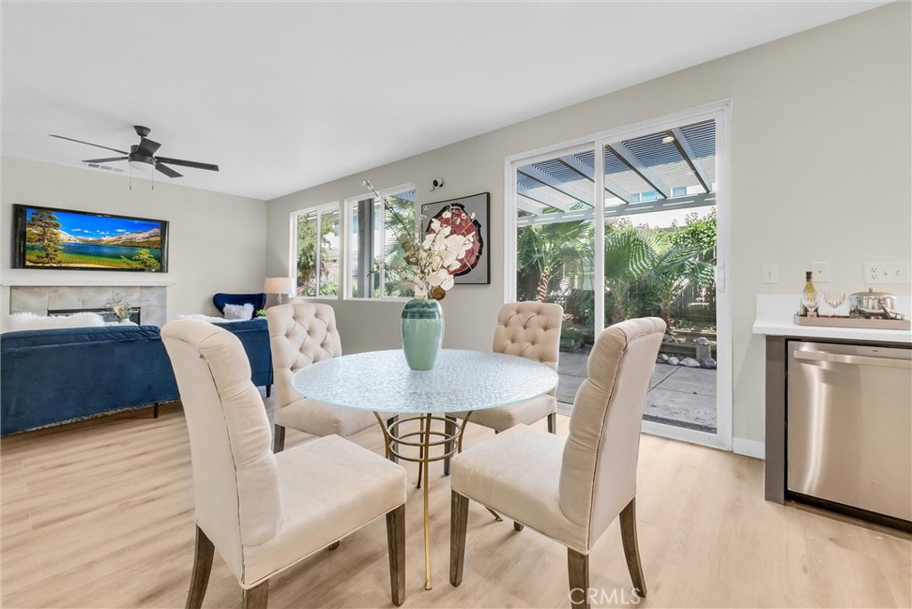6732 Rico Court Eastvale, CA 92880 - Photo 10 of 30 a view of a dining room with furniture a chandelier and wooden floor