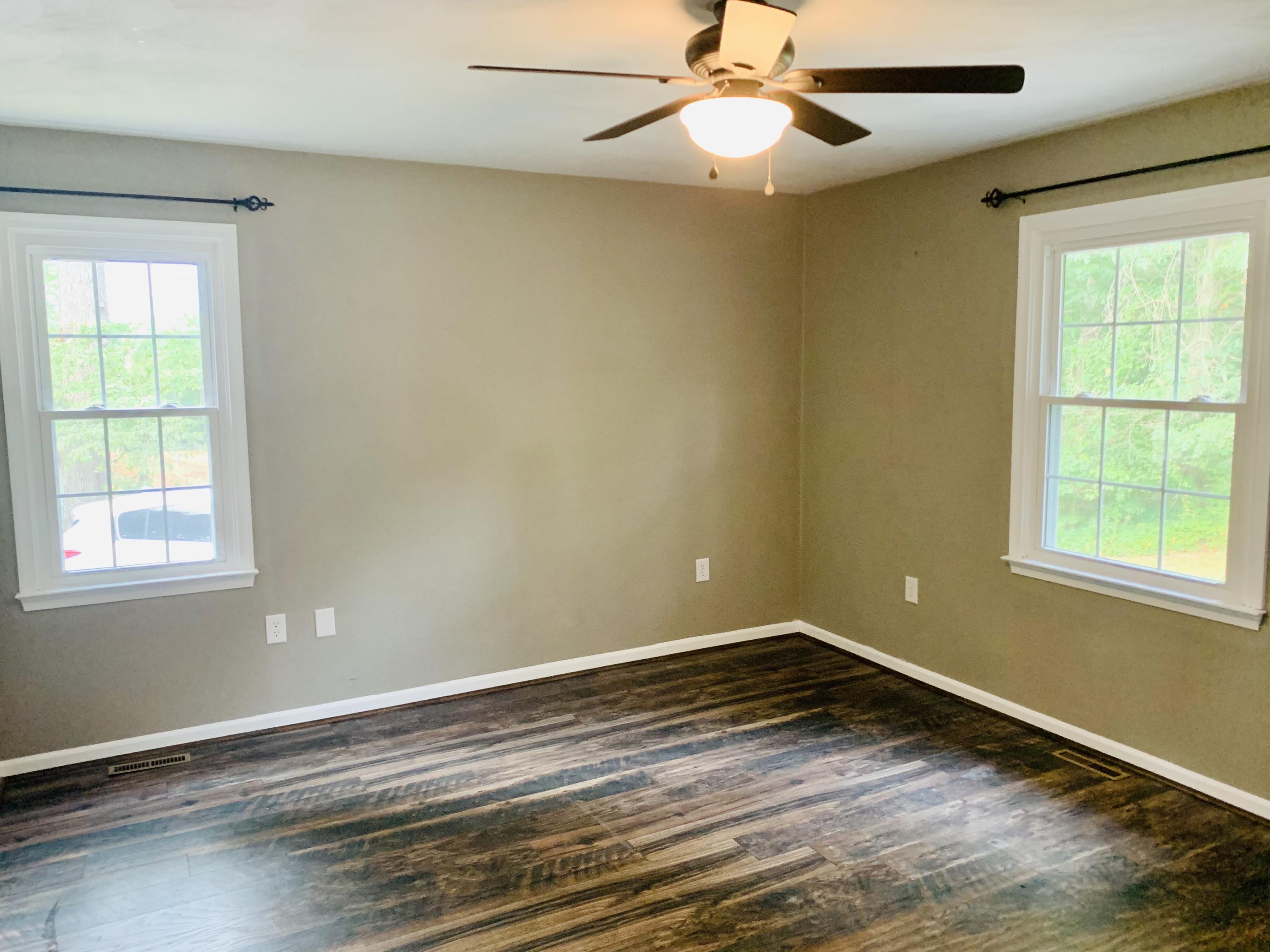 1591 Sandy Level Road Goodview, VA 24095 - Photo 11 of 24 an empty room with a window and wooden floor