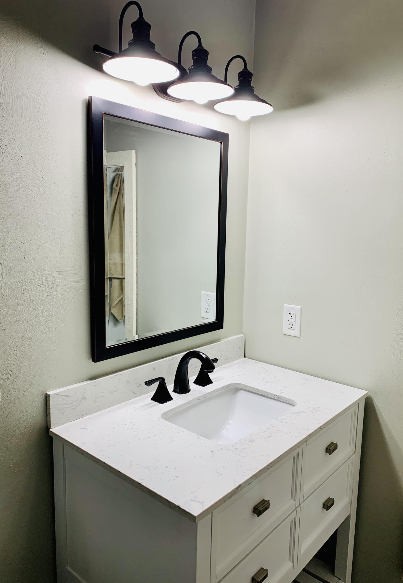 1591 Sandy Level Road Goodview, VA 24095 - Photo 17 of 24 a bathroom with a sink and a mirror
