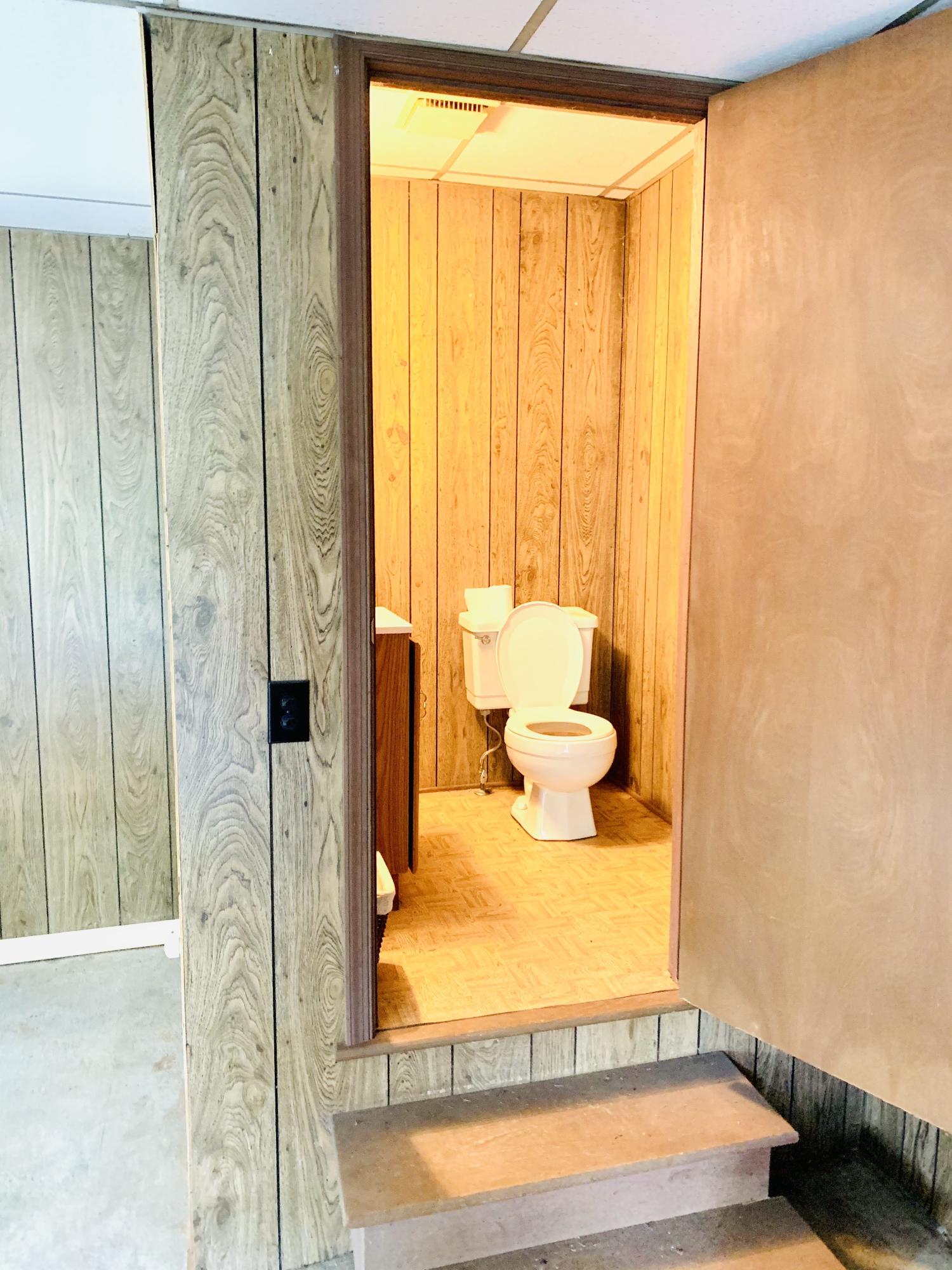 1591 Sandy Level Road Goodview, VA 24095 - Photo 23 of 24 a bathroom with a toilet sink and curtain