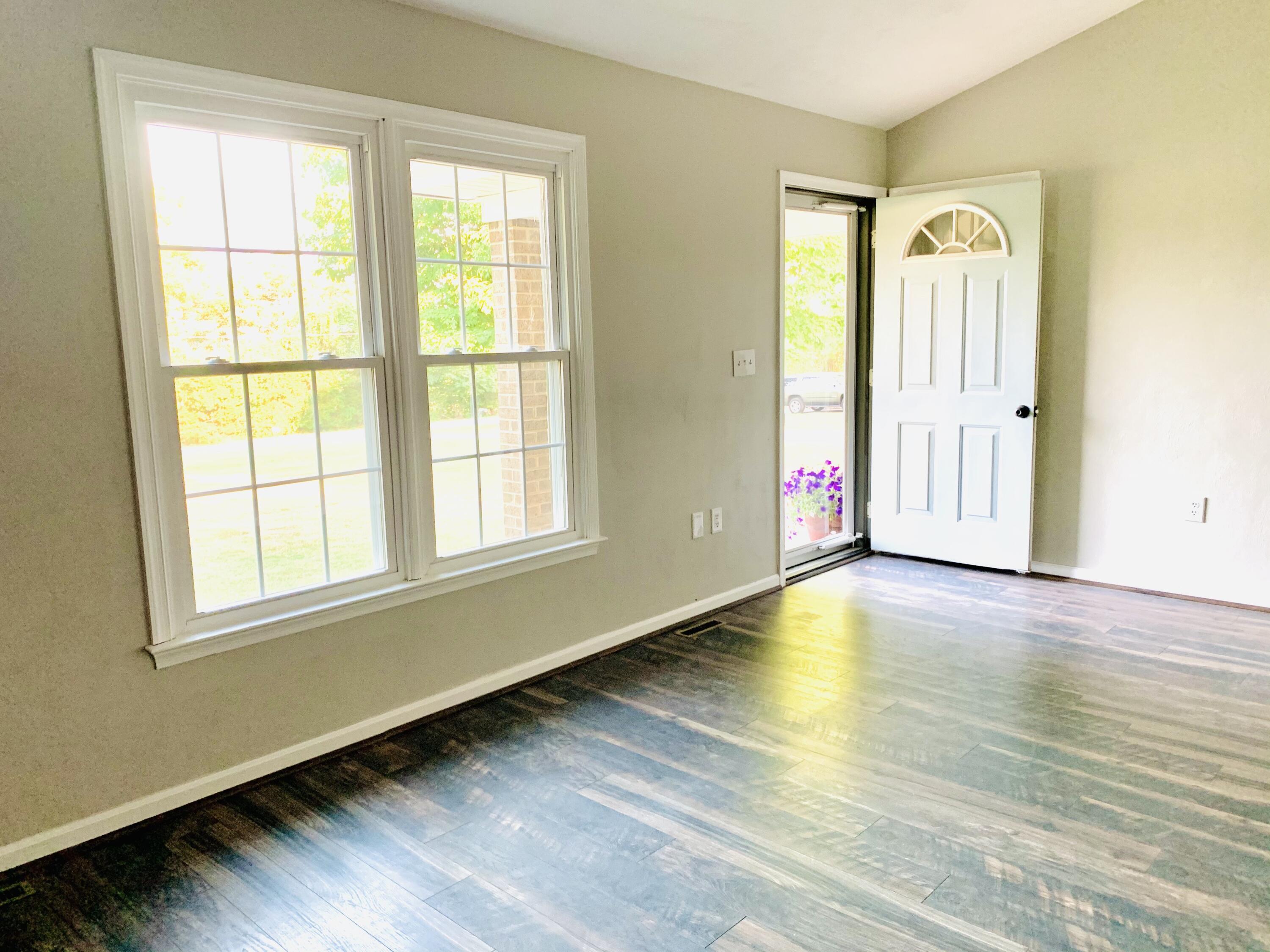 1591 Sandy Level Road Goodview, VA 24095 - Photo 5 of 24 a view of an empty room with a window and wooden floor