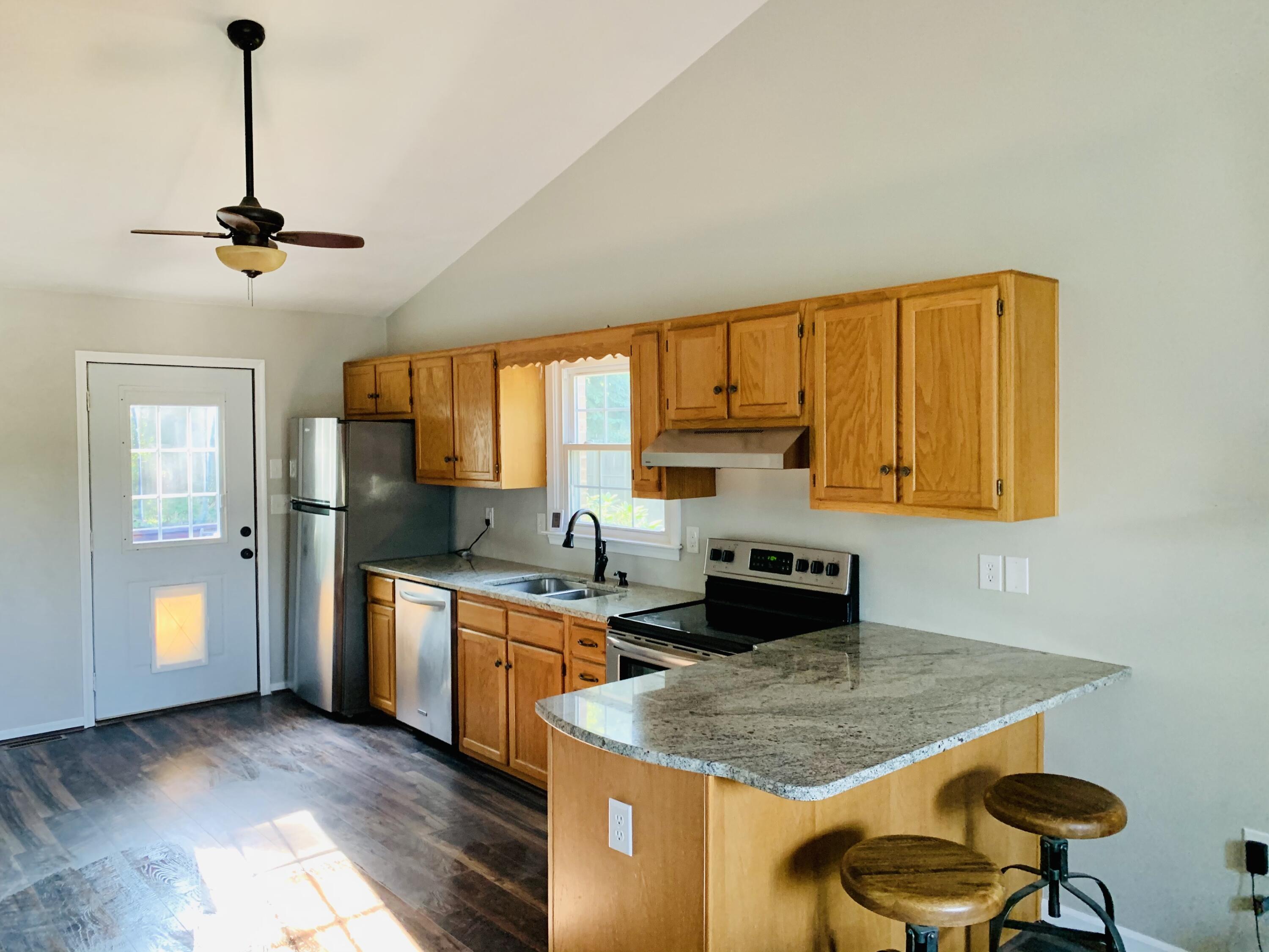 1591 Sandy Level Road Goodview, VA 24095 - Photo 8 of 24 a kitchen with stainless steel appliances granite countertop a sink a stove and refrigerator