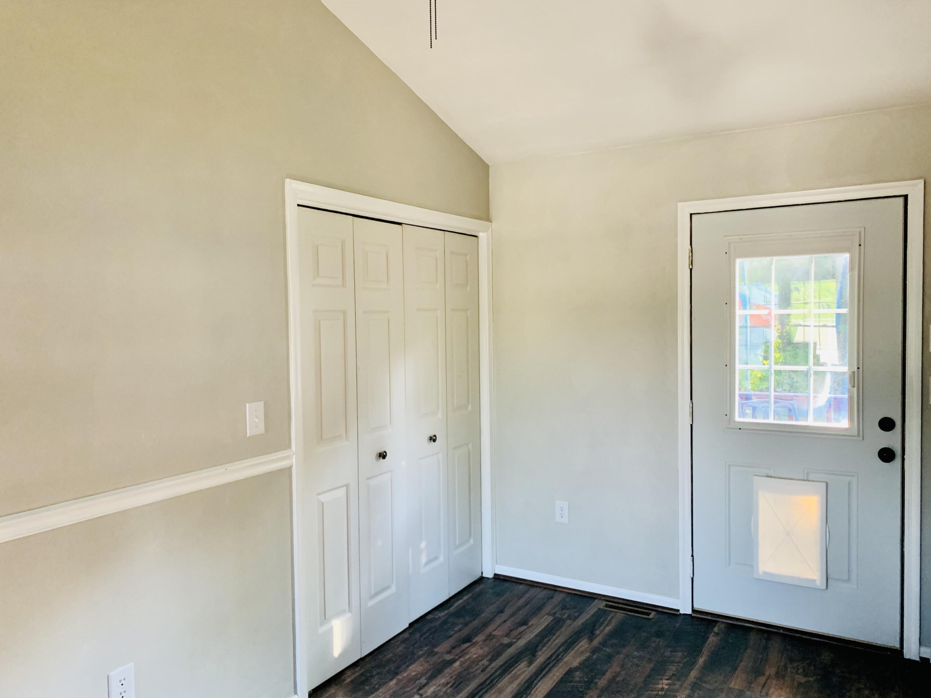 1591 Sandy Level Road Goodview, VA 24095 - Photo 9 of 24 a view of an empty room with wooden floor and closet