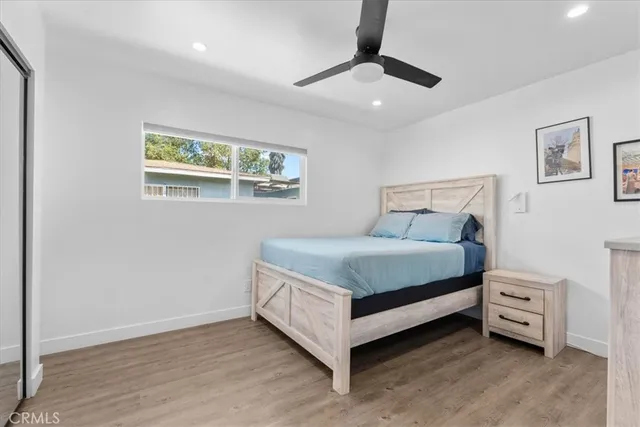 a bed sitting in a bedroom next to a window
