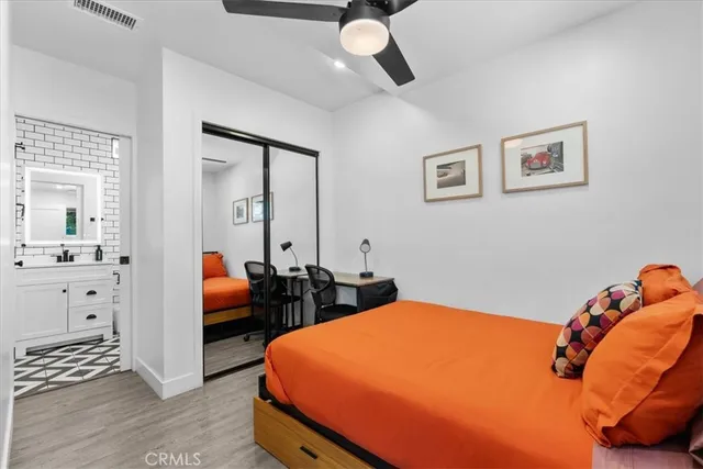 a bedroom with a bed and wooden floor