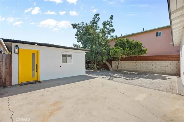 a view of a house with a backyard and garage