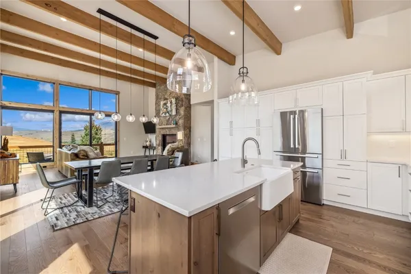 a large white kitchen with a large window