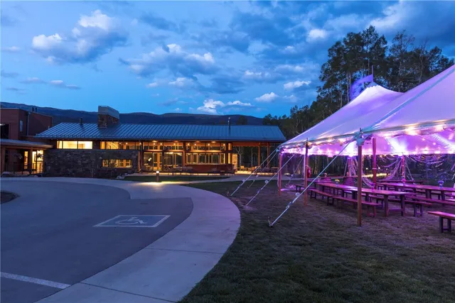 an aerial view of a tennis ground with a table and chairs