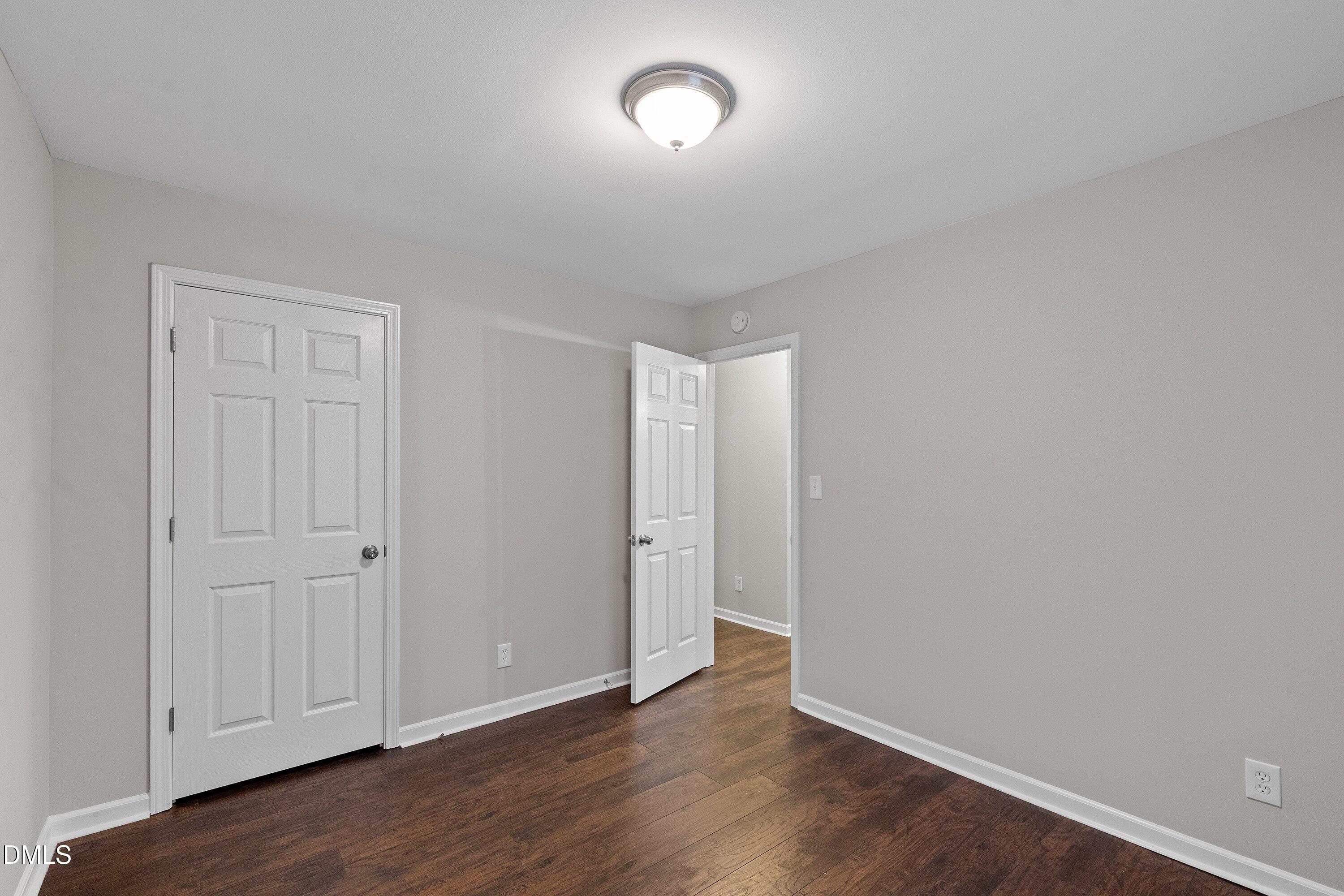 140 Melksham Road Wake Forest, NC 27587 - Photo 21 of 34 an empty room with wooden floor and windows