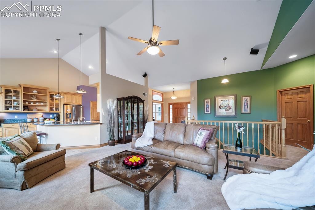 8174 Inca Road Larkspur, CO 80118 - Photo 12 of 50 a living room with furniture and a flat screen tv