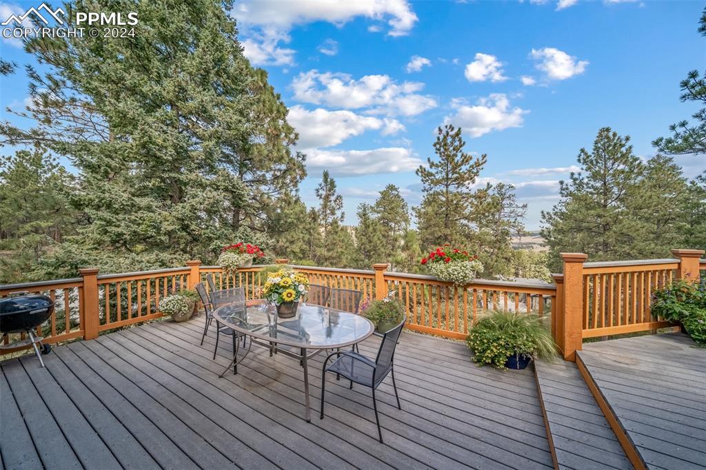 8174 Inca Road Larkspur, CO 80118 - Photo 22 of 50 a view of balcony with deck and outdoor seating