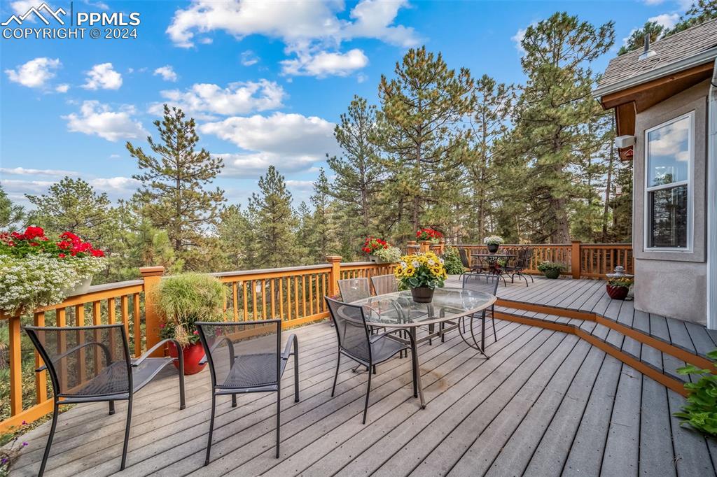 8174 Inca Road Larkspur, CO 80118 - Photo 23 of 50 a view of a chairs and table on the wooden floor