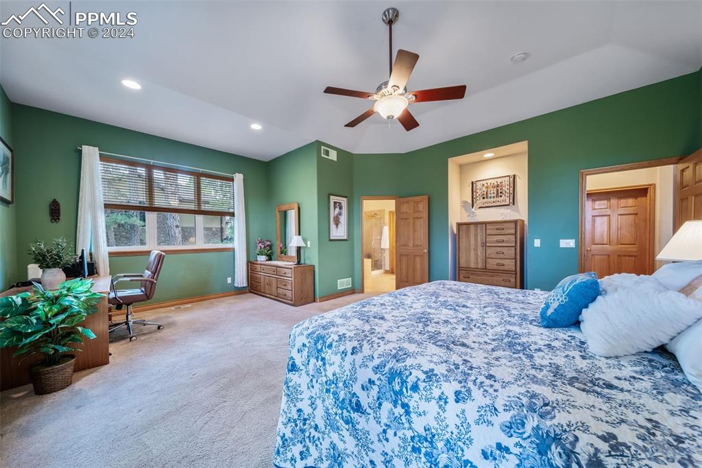 8174 Inca Road Larkspur, CO 80118 - Photo 27 of 50 a bedroom with a bed and ceiling fan