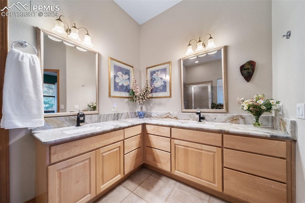 8174 Inca Road Larkspur, CO 80118 - Photo 29 of 50 a bathroom with a sink double vanity granite and a mirror