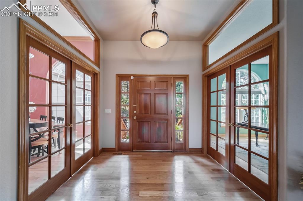 8174 Inca Road Larkspur, CO 80118 - Photo 4 of 50 a view of empty room with wooden floor and windows