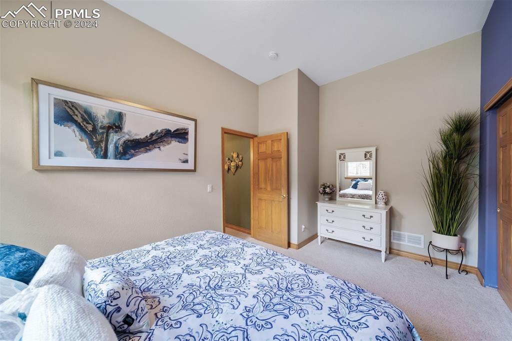 8174 Inca Road Larkspur, CO 80118 - Photo 42 of 50 a bedroom with a bed and a couch