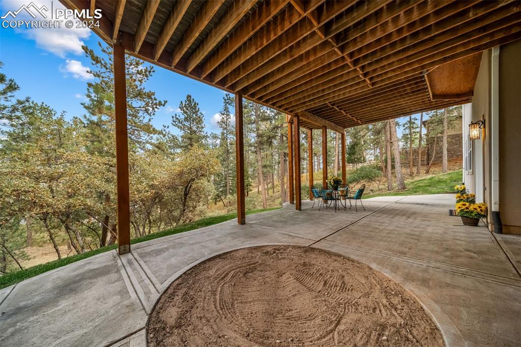 8174 Inca Road Larkspur, CO 80118 - Photo 43 of 50 a view of a room with wooden floor and iron stairs