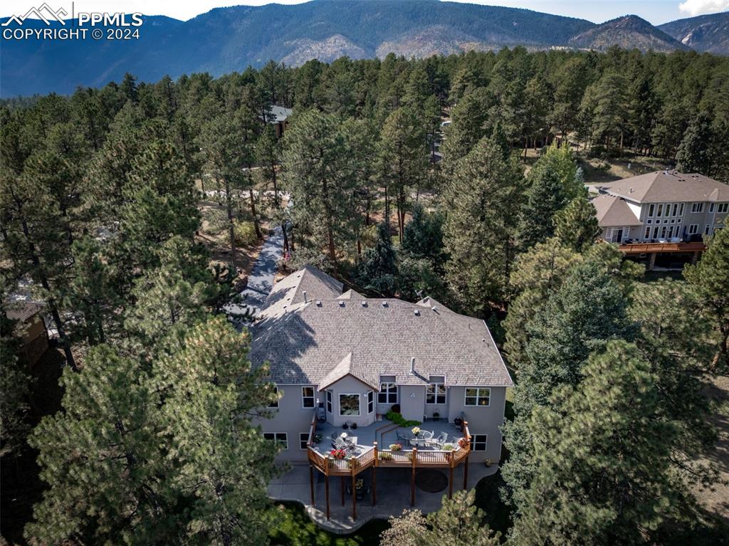 8174 Inca Road Larkspur, CO 80118 - Photo 46 of 50 an aerial view of a house with a garden and mountains
