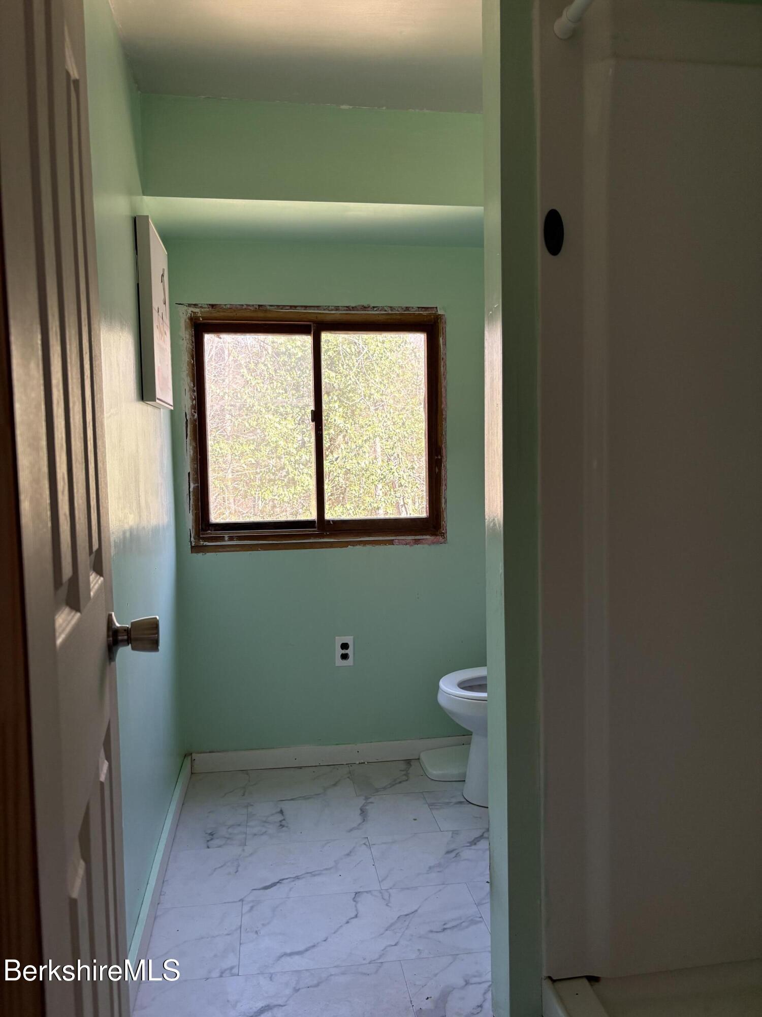 2110 West Center Road Otis, MA 01253 - Photo 11 of 24 a bathroom with a toilet sink and mirror
