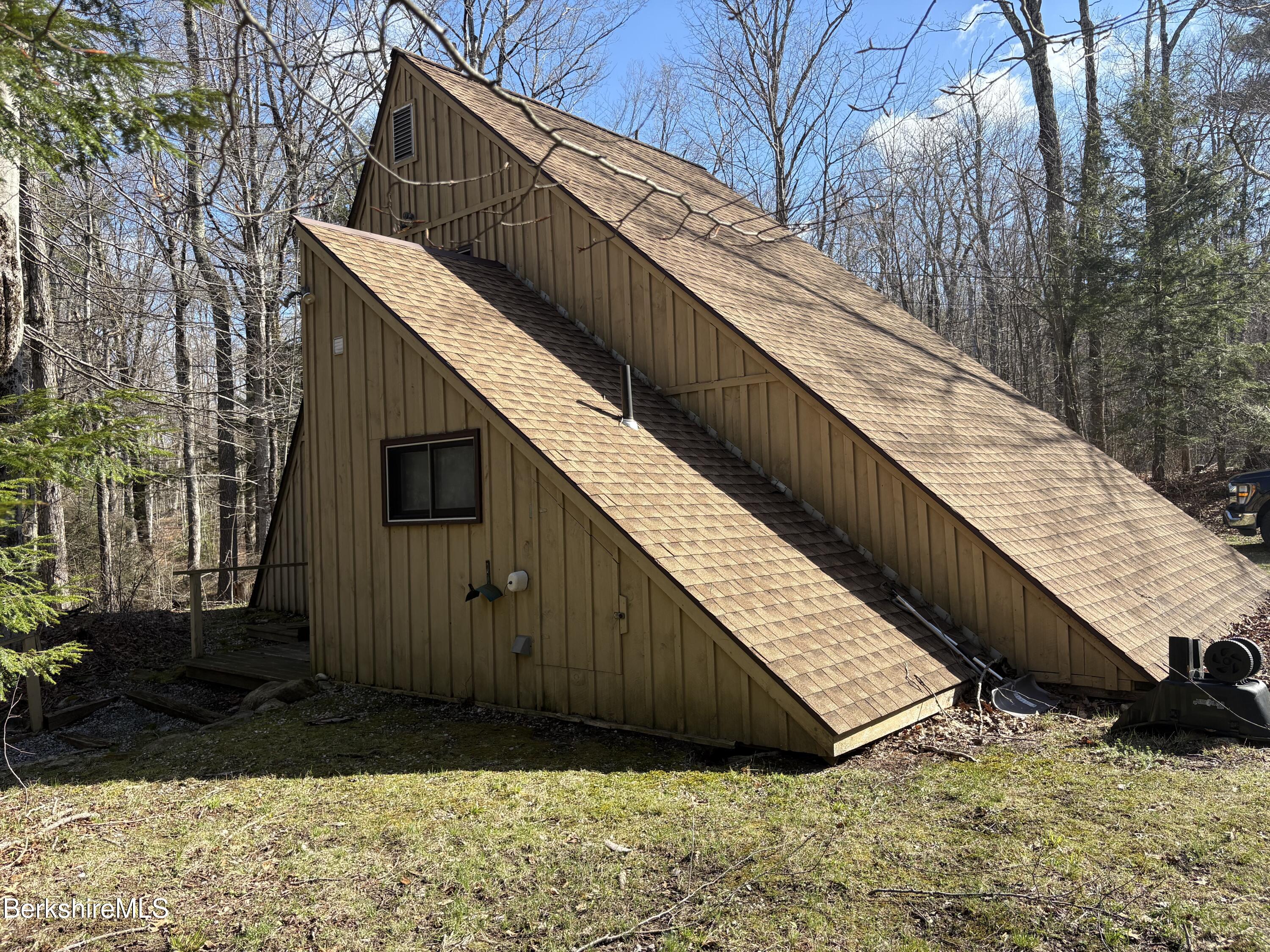 2110 West Center Road Otis, MA 01253 - Photo 19 of 24 a view of a house with a wooden fence